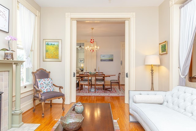 living room with light hardwood / wood-style flooring and a chandelier