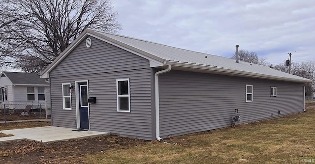 back of property with a patio and a lawn