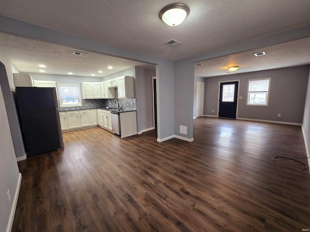 kitchen featuring stainless steel appliances, a textured ceiling, backsplash, and dark hardwood / wood-style flooring