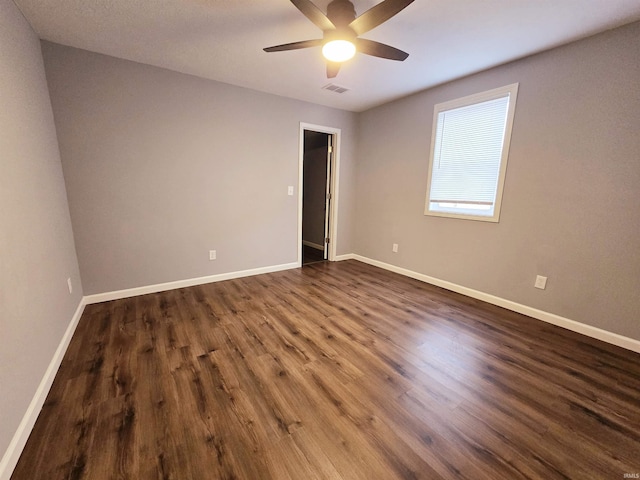 empty room featuring ceiling fan and dark hardwood / wood-style floors