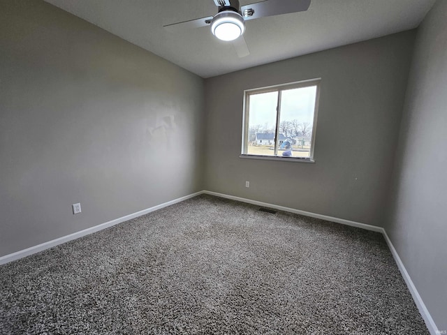 empty room featuring carpet flooring and ceiling fan