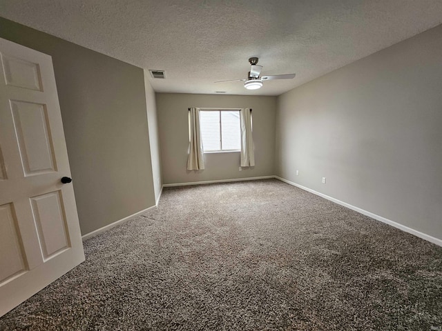 carpeted empty room featuring ceiling fan and a textured ceiling