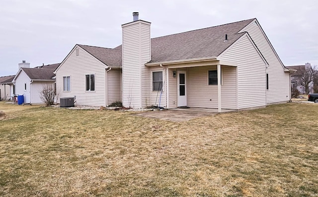 back of property with a yard, central AC, and a patio