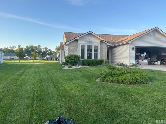 view of front of property with a garage and a front lawn