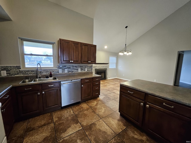 kitchen featuring stainless steel dishwasher, dark brown cabinetry, sink, and hanging light fixtures