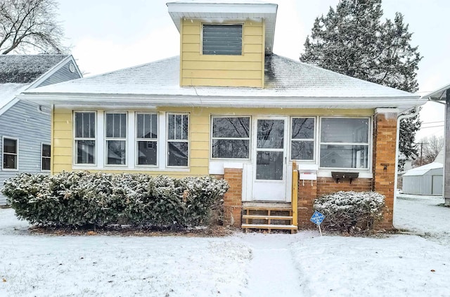 view of snow covered house