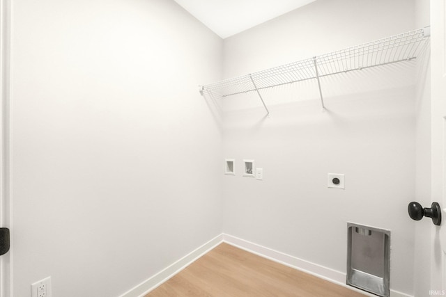 laundry area with electric dryer hookup, hookup for a washing machine, and wood-type flooring