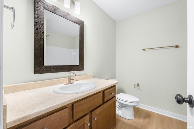 bathroom featuring hardwood / wood-style flooring, vanity, and toilet