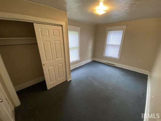 unfurnished bedroom with a closet