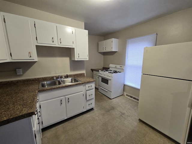 kitchen with white cabinetry, white appliances, and sink