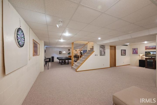 interior space featuring carpet flooring and a drop ceiling