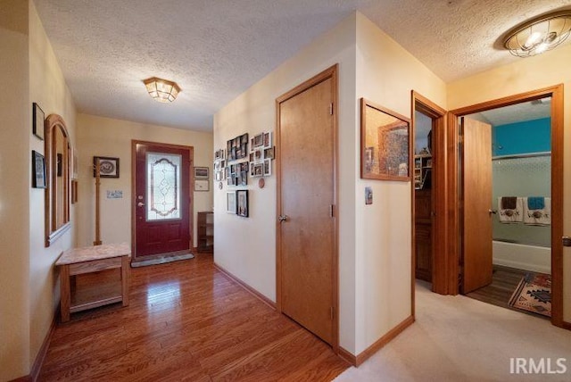 foyer with hardwood / wood-style floors and a textured ceiling