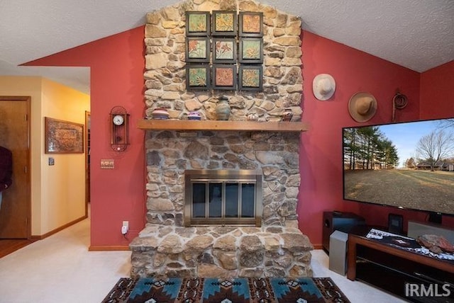 living room featuring lofted ceiling, carpet floors, a fireplace, and a textured ceiling