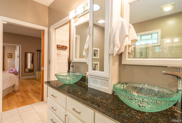 bathroom with tile patterned floors, vanity, and a shower