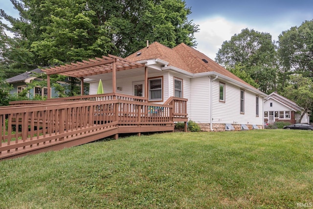 rear view of house with a wooden deck, a yard, and a pergola