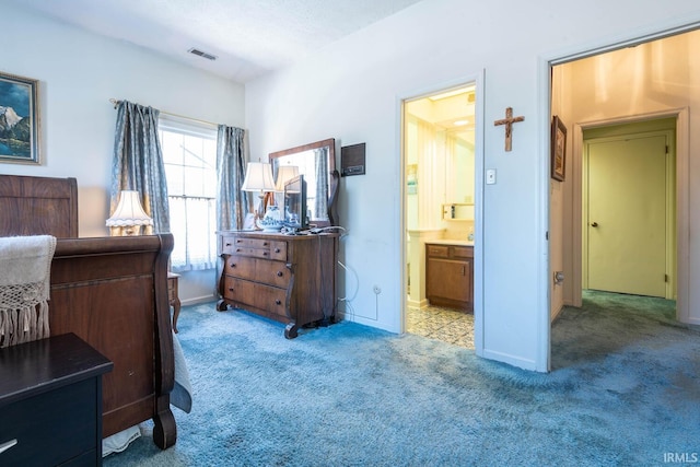 carpeted bedroom featuring connected bathroom