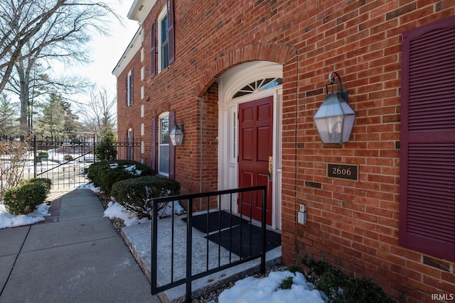 view of snow covered property entrance