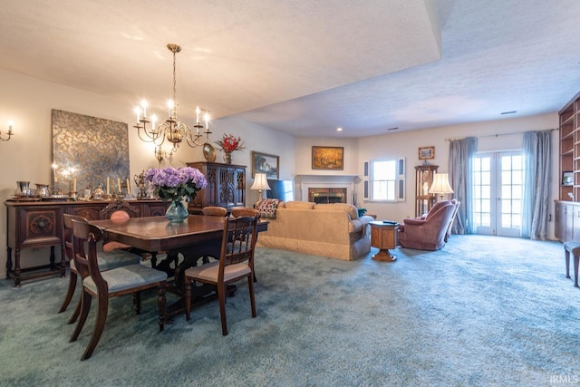 dining area with french doors, carpet flooring, an inviting chandelier, and a textured ceiling