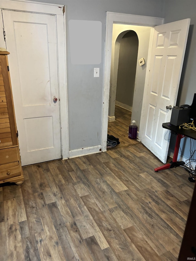 unfurnished bedroom featuring dark wood-type flooring