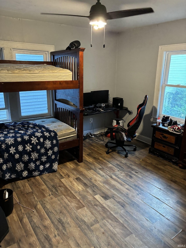 bedroom with ceiling fan and wood-type flooring