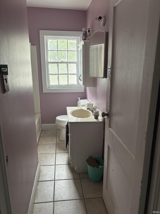 bathroom with tile patterned flooring, vanity, and toilet