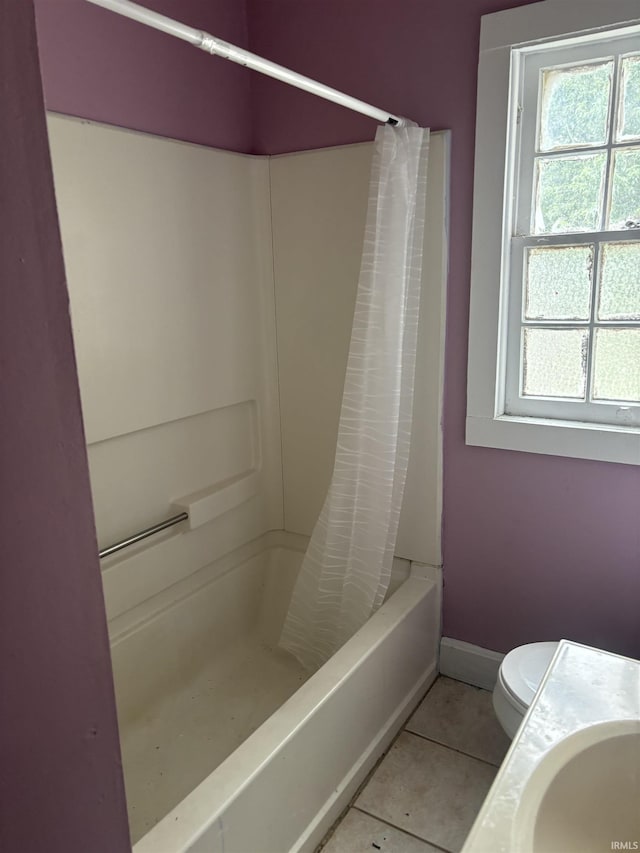 bathroom with sink, toilet, and tile patterned flooring