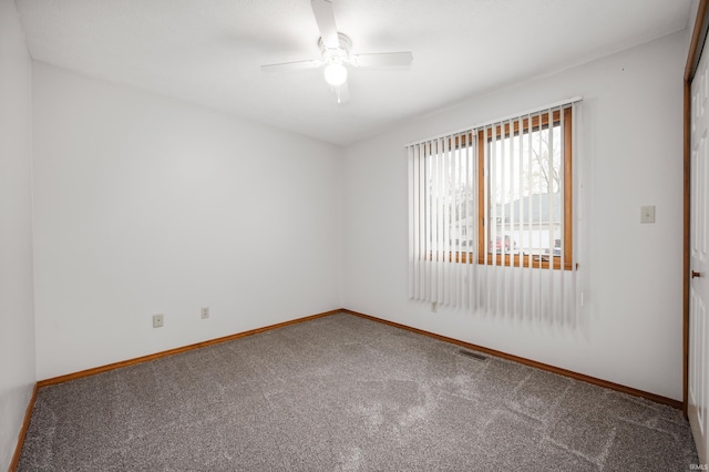 carpeted empty room featuring ceiling fan