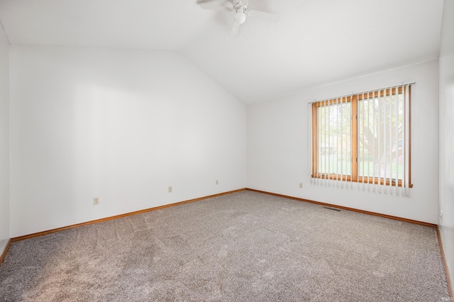 carpeted empty room with lofted ceiling and ceiling fan