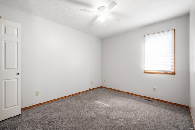 unfurnished room with ceiling fan, carpet flooring, and a textured ceiling