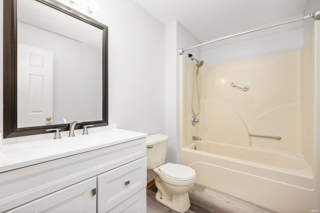 full bathroom featuring vanity, hardwood / wood-style floors, shower / bathtub combination, and toilet