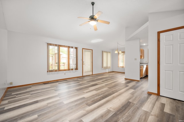 unfurnished living room with vaulted ceiling, ceiling fan, and light wood-type flooring