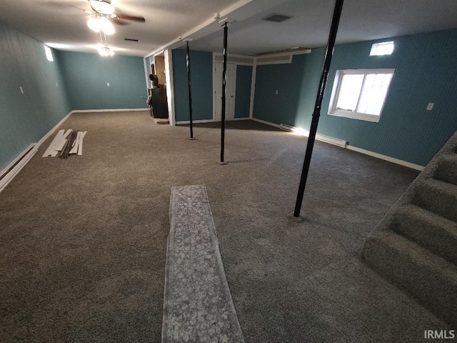 basement with dark colored carpet and a baseboard heating unit