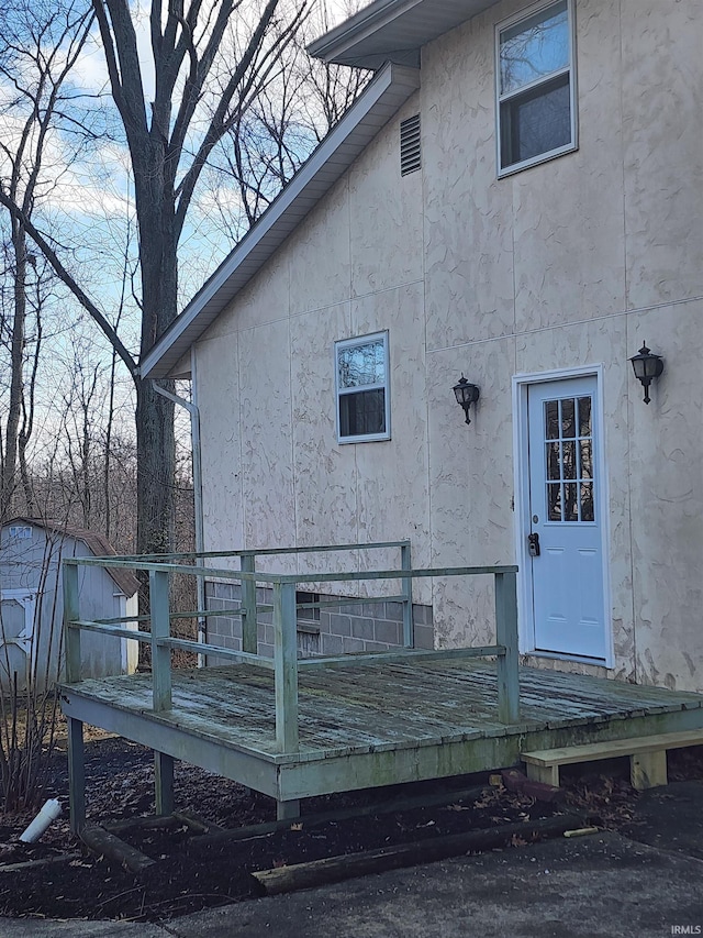 rear view of property with a wooden deck