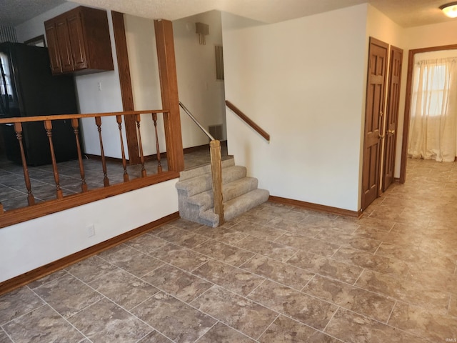 basement featuring black fridge