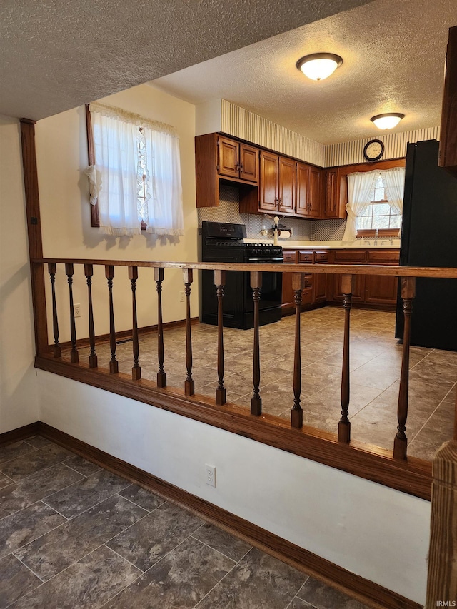 kitchen featuring gas stove and a textured ceiling