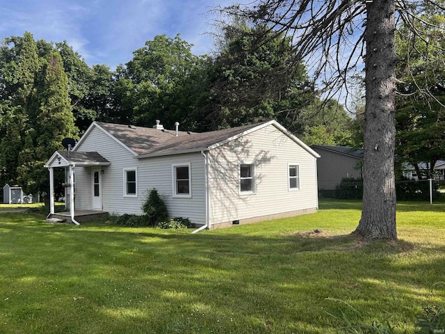 rear view of property featuring a yard