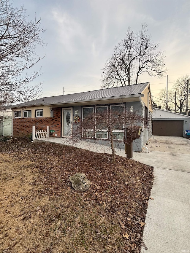 single story home with a garage and an outdoor structure