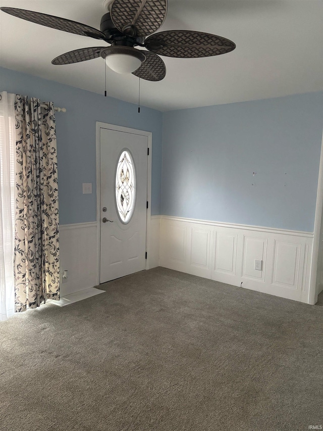 carpeted entrance foyer with ceiling fan