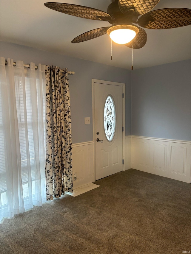 carpeted entrance foyer with ceiling fan