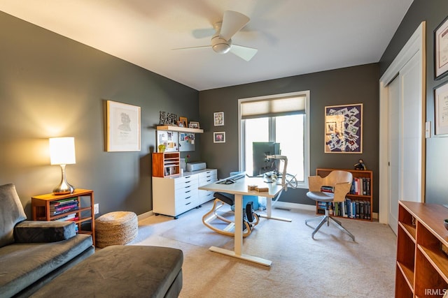 home office featuring ceiling fan and light colored carpet