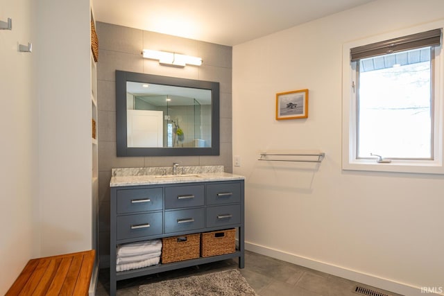 bathroom featuring tile patterned flooring and vanity