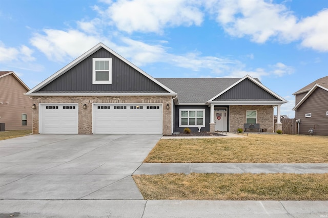 craftsman house featuring a garage and a front lawn