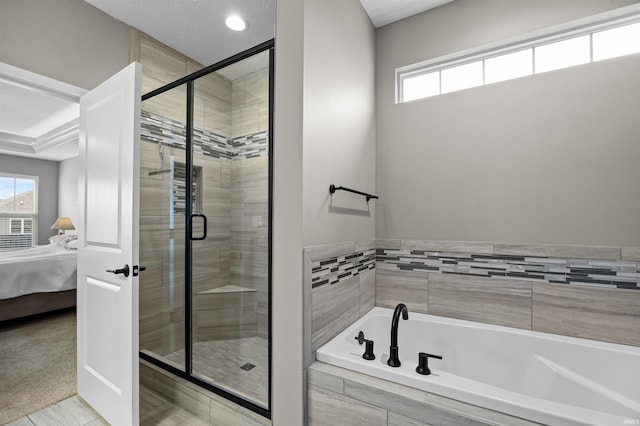 bathroom with a healthy amount of sunlight and shower with separate bathtub