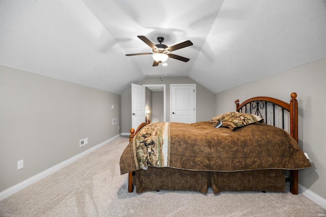 bedroom with lofted ceiling, light colored carpet, and ceiling fan