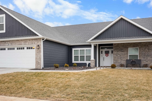 craftsman-style home featuring a garage and a front lawn