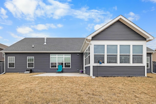 rear view of house with a lawn and a patio area