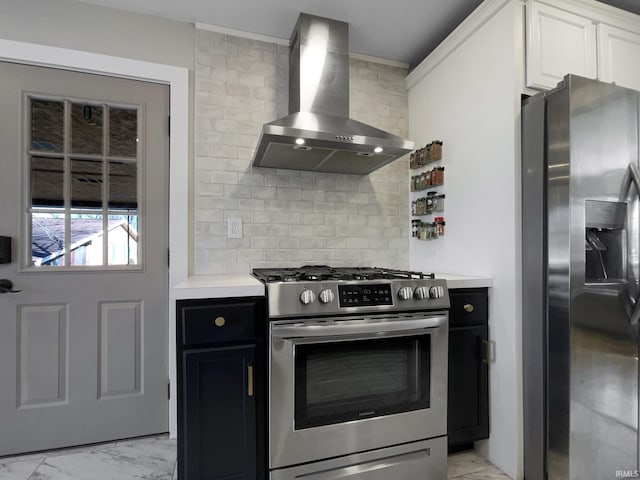 kitchen with wall chimney exhaust hood, stainless steel appliances, backsplash, and white cabinets