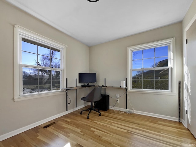 home office featuring plenty of natural light and light hardwood / wood-style floors