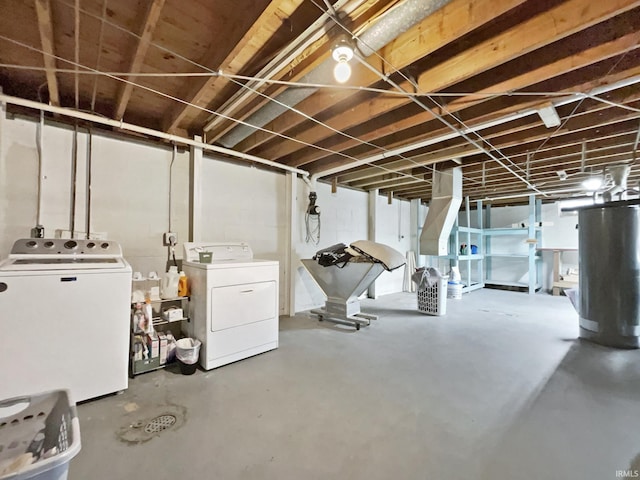 basement with gas water heater and washing machine and dryer