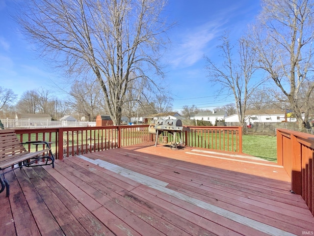 wooden terrace with a lawn